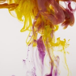 Colorful abstract display of yellow, pink, and purple ink flowing in water.